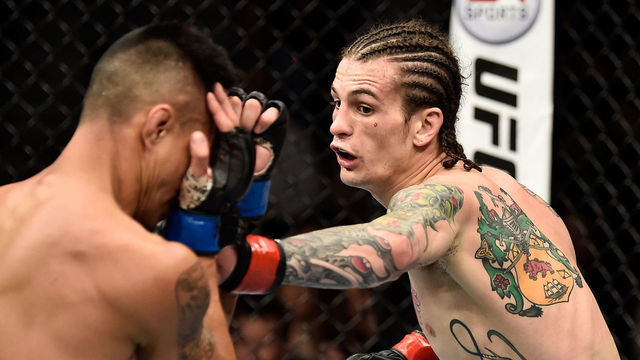 LAS VEGAS, NV - MARCH 03: (R-L) Sean O'Malley punches Andre Soukhamthath in their bantamweight bout during the UFC 222 event inside T-Mobile Arena on March 3, 2018 in Las Vegas, Nevada.