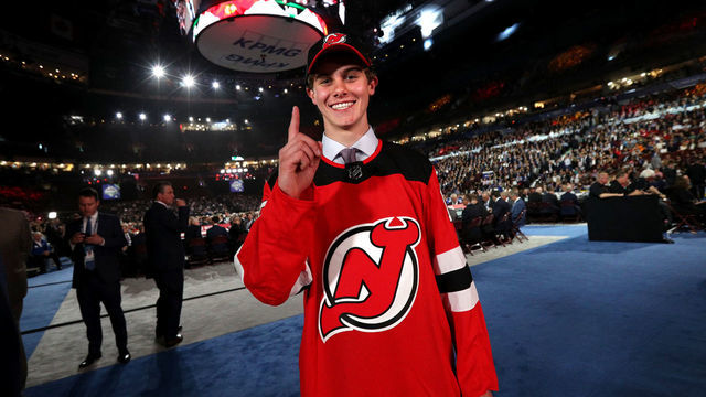 VANCOUVER, BRITISH COLUMBIA - JUNE 21: Jack Hughes, first overall pick by the New Jersey Devils, holds up a finger for number one on the draft floor during the first round of the 2019 NHL Draft at Rogers Arena on June 21, 2019 in Vancouver, Canada.