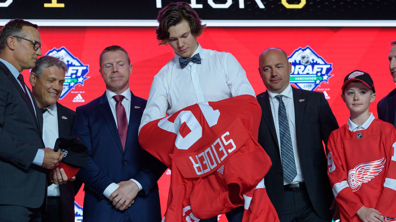 VANCOUVER, BC - JUNE 21: Moritz Seider puts on a jersey after being selected sixth overall by the Detroit Red Wings during the first round of the 2019 NHL Draft at Rogers Arena on June 21, 2019 in Vancouver, British Columbia, Canada.