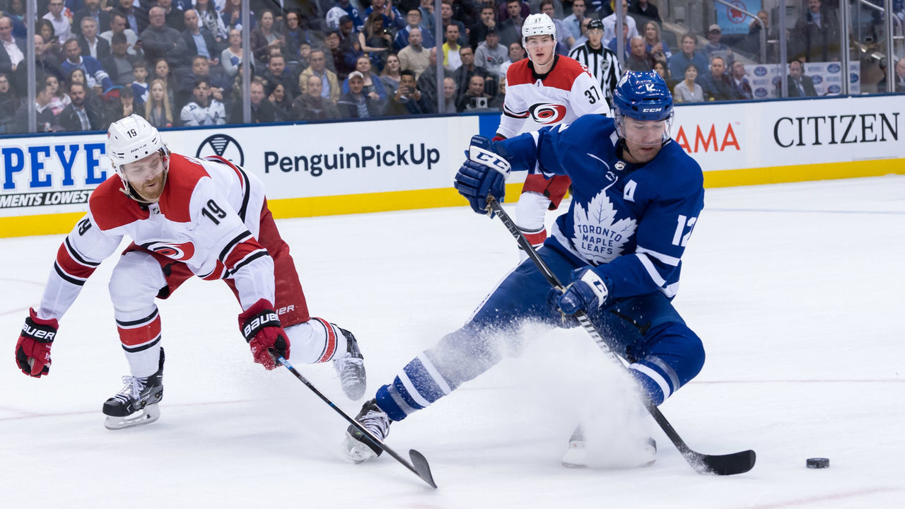 TORONTO, ON - APRIL 02: Carolina Hurricanes Defenceman Dougie Hamilton (19) defends Toronto Maple Leafs Left Wing Patrick Marleau (12) during the NHL regular season game between the Carolina Hurricanes and the Toronto Maple Leafs on April 2, 2019, at Scotiabank Arena in Toronto, ON, Canada.