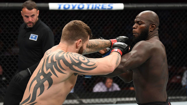 GREENVILLE, SC - JUNE 22: (R-L) Jairzinho Rozenstruik of Suriname punches Allen Crowder in their heavyweight bout during the UFC Fight Night event at Bon Secours Wellness Arena on June 22, 2019 in Greenville, South Carolina.