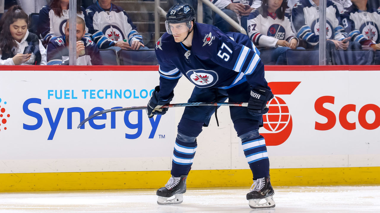 WINNIPEG, MB - APRIL 18: Tyler Myers #57 of the Winnipeg Jets gets set during a second period face-off against the St. Louis Blues in Game Five of the Western Conference First Round during the 2019 NHL Stanley Cup Playoffs at the Bell MTS Place on April 18, 2019 in Winnipeg, Manitoba, Canada. The Blues defeated the Jets 3-2 to lead the series 3-2.