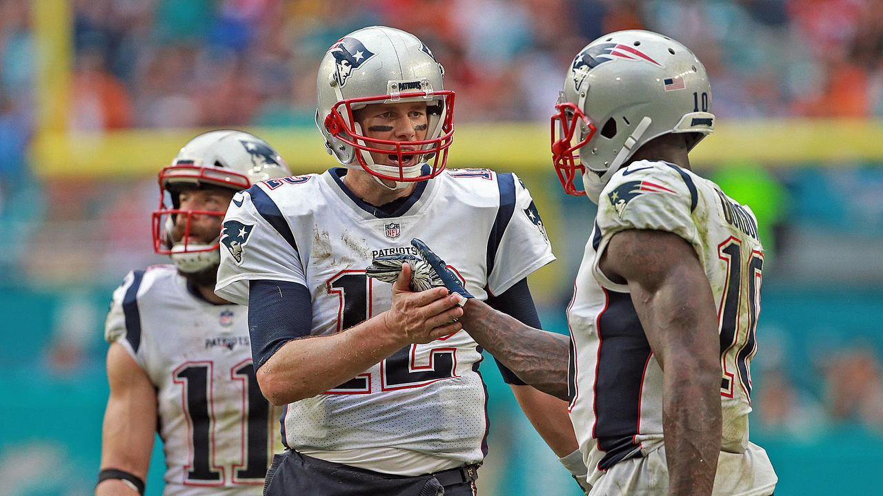 MIAMI GARDENS, FL - DECEMBER 9: Tom Brady #12 of the New England Patriots high fives Josh Gordon #10 of the New England Patriots during the fourth quarter of the NFL game against the Miami Dolphins at Hard Rock Stadium on December 9, 2018 in Miami Gardens, Florida. (Staff Photo By Matt Stone/ Boston Herald)