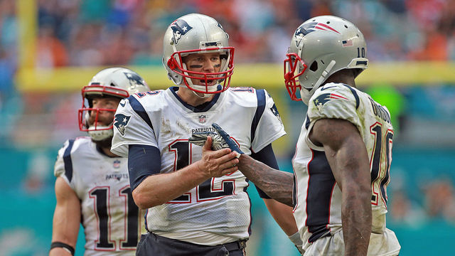 MIAMI GARDENS, FL - DECEMBER 9: Tom Brady #12 of the New England Patriots high fives Josh Gordon #10 of the New England Patriots during the fourth quarter of the NFL game against the Miami Dolphins at Hard Rock Stadium on December 9, 2018 in Miami Gardens, Florida. (Staff Photo By Matt Stone/ Boston Herald)