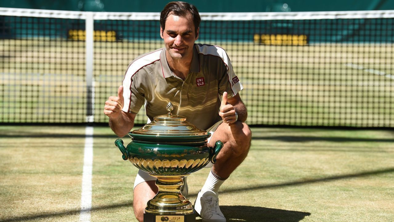 Roger Federer from Switzerland poses with the trophy after he won his final match against David Goffin from Belgium at the ATP tennis tournament in Halle, western Germany, on June 23, 2019.