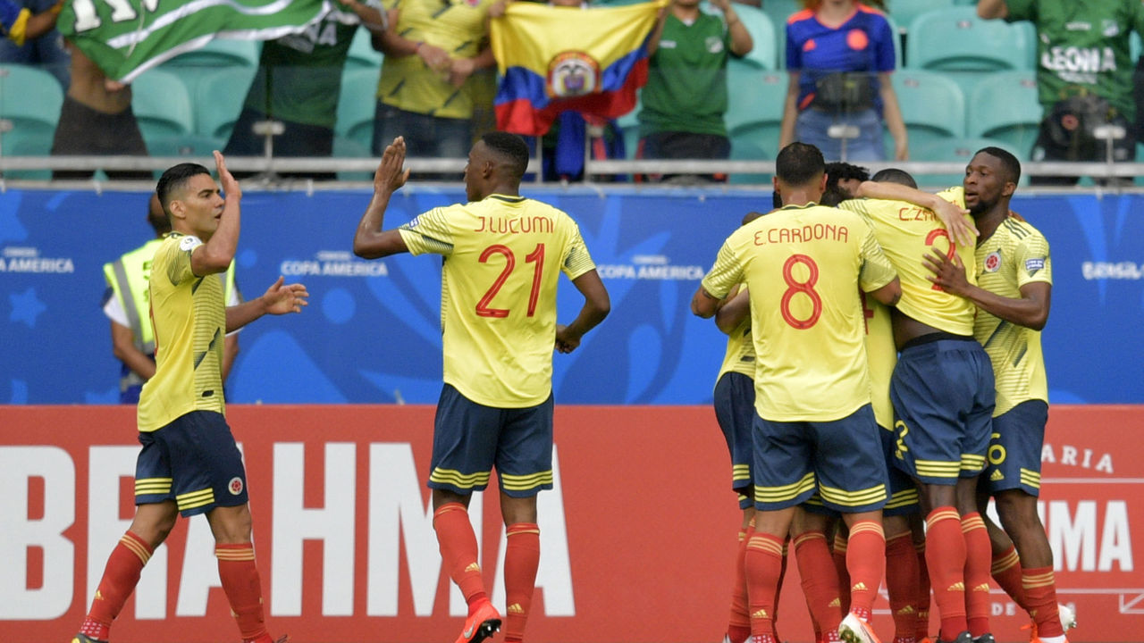 Colombia's Gustavo Cuellar (covered) celebrates with teammates after scoring against Paraguay during their Copa America football tournament group match at the Fonte Nova Arena in Salvador, Brazil, on June 23, 2019.