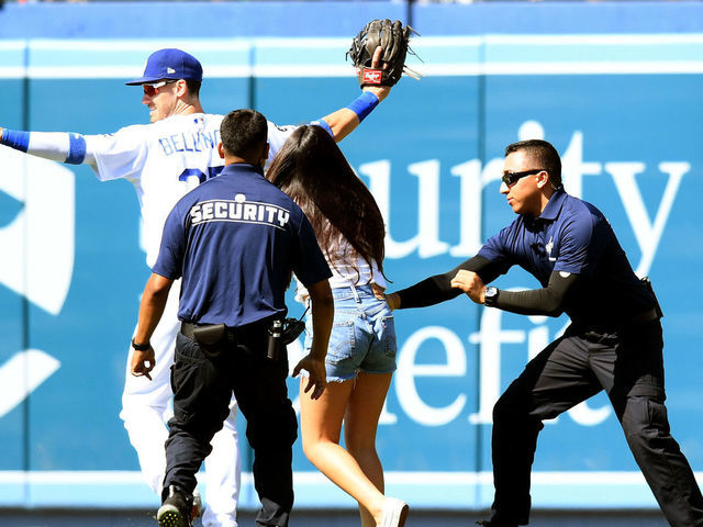 LOS ANGELES, CALIFORNIA - JUNE 23: Cody Bellinger #35 of the Los Angeles Dodgers reacts as a fan chases after him on the field during the ninth inning against the Colorado Rockies at Dodger Stadium on June 23, 2019 in Los Angeles, California.