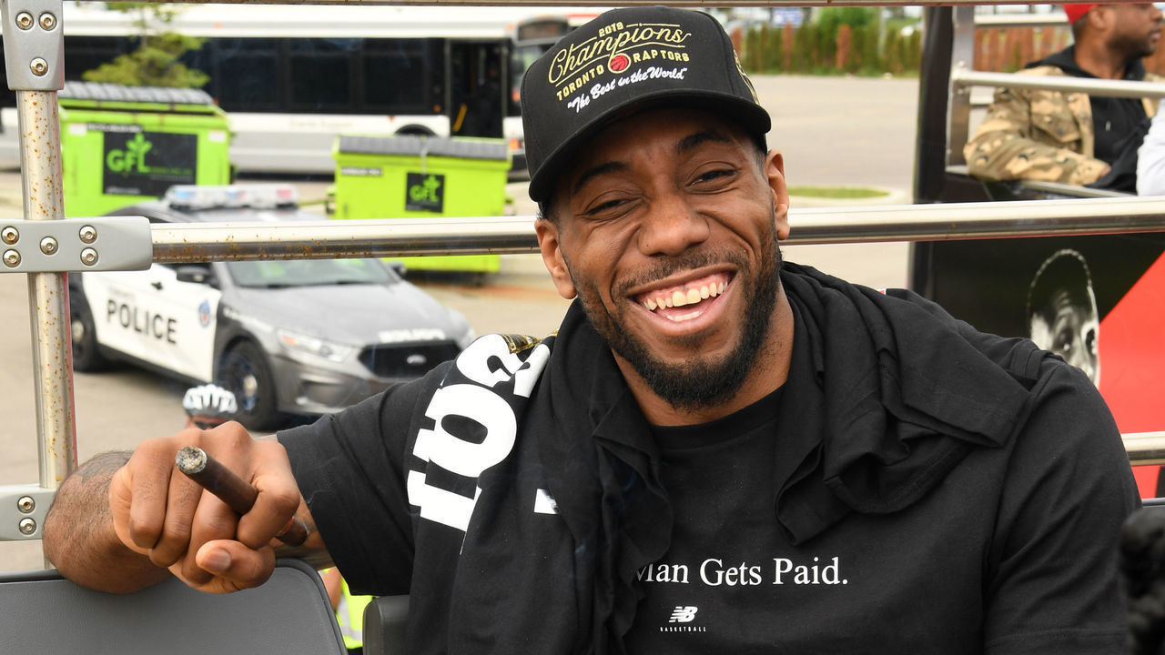 TORONTO, ON - JUNE 17: Kawhi Leonard #2 of the Toronto Raptors is photographed with the Larry O'Brien Championship Trophy on the team bus during the Toronto Raptors Championship Victory Parade on June 17, 2019 in Toronto, Ontario. NOTE TO USER: User expressly acknowledges and agrees that, by downloading and/or using this photograph, user is consenting to the terms and conditions of Getty Images License Agreement. Mandatory Copyright Notice: Copyright 2019 NBAE