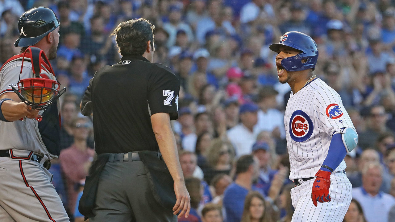 CHICAGO, ILLINOIS - JUNE 24: Willson Contreras #40 of the Chicago Cubs has words with Tyler Flowers #25 of the Atlanta Braves and home plate umpire John Tumpane #74 after hitting a solo home run in the 2nd inning against the Atlanta Braves at Wrigley Field on June 24, 2019 in Chicago, Illinois.