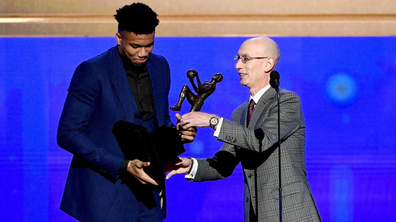SANTA MONICA, CALIFORNIA - JUNE 24: (L-R) Giannis Antetokounmpo accepts the Kia NBA Most Valuable Player award from NBA Commissioner Adam Silver onstage during the 2019 NBA Awards presented by Kia on TNT at Barker Hangar on June 24, 2019 in Santa Monica, California.