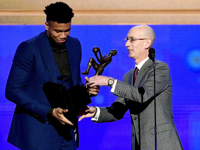 SANTA MONICA, CALIFORNIA - JUNE 24: (L-R) Giannis Antetokounmpo accepts the Kia NBA Most Valuable Player award from NBA Commissioner Adam Silver onstage during the 2019 NBA Awards presented by Kia on TNT at Barker Hangar on June 24, 2019 in Santa Monica, California.