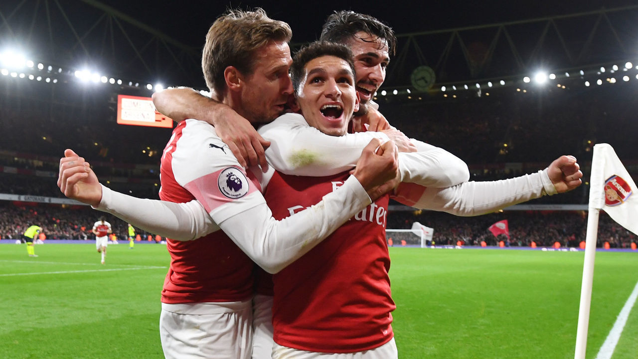 LONDON, ENGLAND - DECEMBER 08: (2ndL) Lucas Torreira celebrates his goal with (L) Nacho Monreal and (R) Sead Kolasinac during the Premier League match between Arsenal FC and Huddersfield Town at Emirates Stadium on December 8, 2018 in London, United Kingdom.
