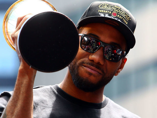 TORONTO, ON - JUNE 17: Kawhi Leonard #2 of the Toronto Raptors holds the MVP trophy during the Toronto Raptors Victory Parade on June 17, 2019 in Toronto, Canada. The Toronto Raptors beat the Golden State Warriors 4-2 to win the 2019 NBA Finals.