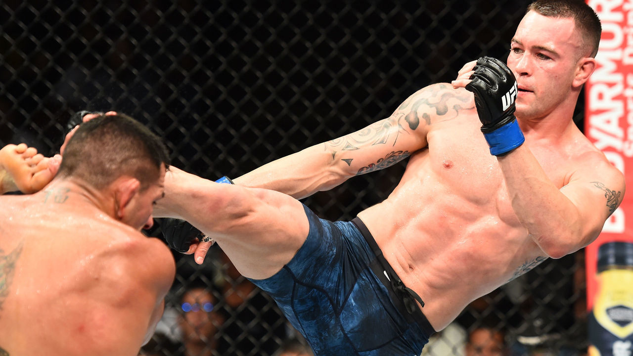 CHICAGO, ILLINOIS - JUNE 09: (R-L) Colby Covington kicks the head of Rafael Dos Anjos of Brazil in their interim welterweight title fight during the UFC 225 event at the United Center on June 9, 2018 in Chicago, Illinois.