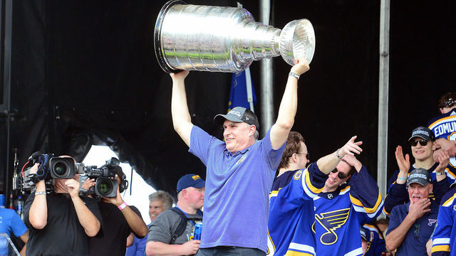 ST LOUIS, MO - JUN 15: St. Louis Blues interim head coach Craig Berube hoists the Stanley Cup at a ports-parade rally on the Arch Grounds after the St. Louis Blues victory parade held on June 15, 2019, in downtown, St. Louis, Mo.