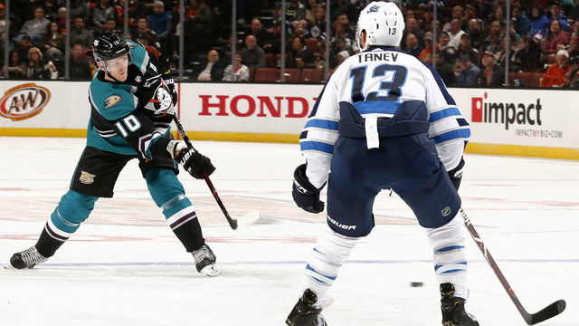 ANAHEIM, CA - MARCH 20: Corey Perry #10 of the Anaheim Ducks releases a shot against Brandon Tanev #13 of the Winnipeg Jets during the game on March 20, 2019 at Honda Center in Anaheim, California.
