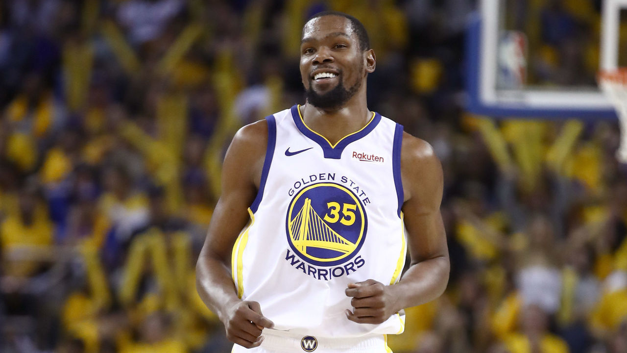 OAKLAND, CALIFORNIA - APRIL 13: Kevin Durant #35 of the Golden State Warriors smiles during their game against the LA Clippers during Game One of the first round of the 2019 NBA Western Conference Playoffs at ORACLE Arena on April 13, 2019 in Oakland, California.