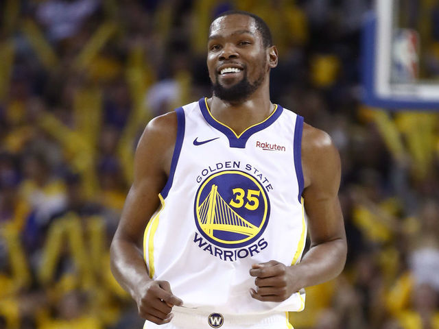 OAKLAND, CALIFORNIA - APRIL 13: Kevin Durant #35 of the Golden State Warriors smiles during their game against the LA Clippers during Game One of the first round of the 2019 NBA Western Conference Playoffs at ORACLE Arena on April 13, 2019 in Oakland, California.