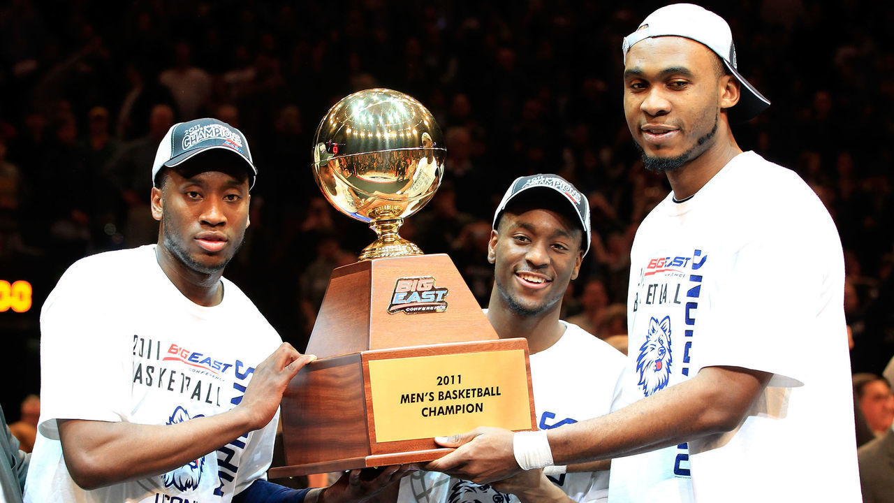 NEW YORK, NY - MARCH 12: Donnell Beverly #2, Kemba Walker #15 and Charles Okwandu #35 of the Connecticut Huskies hold up the Championship trophy after defeating the Louisville Cardinals during the championship of the 2011 Big East Men's Basketball Tournament presented by American Eagle Outfitters at Madison Square Garden on March 12, 2011 in New York City.