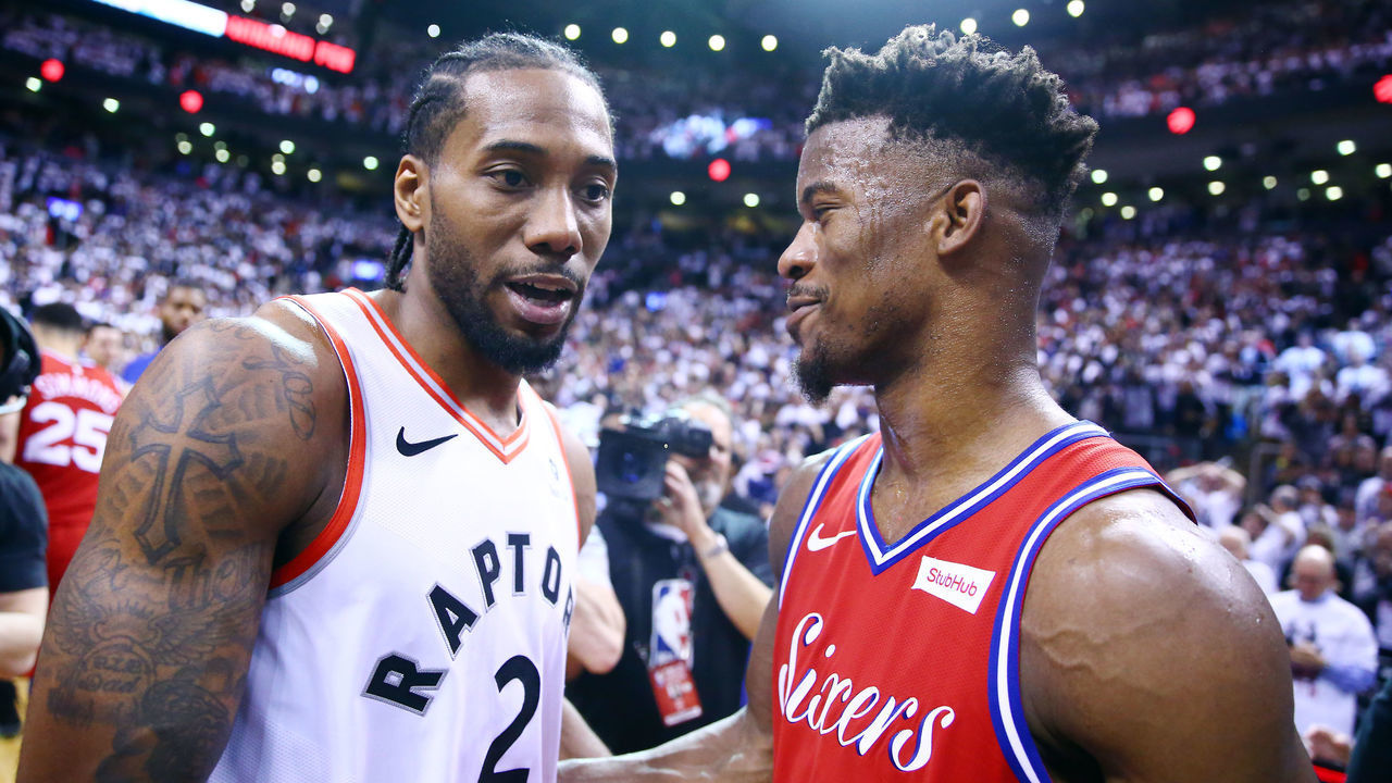 TORONTO, ON - MAY 12: Kawhi Leonard #2 of the Toronto Raptors speaks with Jimmy Butler #23 of the Philadelphia 76ers after sinking a buzzer beater to win Game Seven of the second round of the 2019 NBA Playoffs at Scotiabank Arena on May 12, 2019 in Toronto, Canada.
