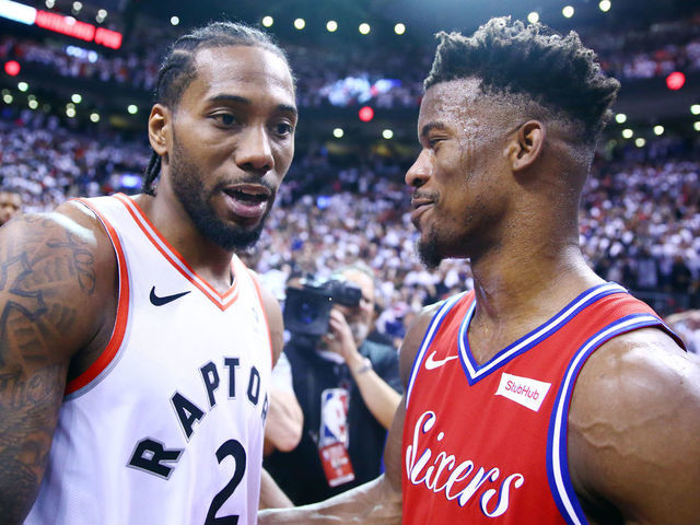 TORONTO, ON - MAY 12: Kawhi Leonard #2 of the Toronto Raptors speaks with Jimmy Butler #23 of the Philadelphia 76ers after sinking a buzzer beater to win Game Seven of the second round of the 2019 NBA Playoffs at Scotiabank Arena on May 12, 2019 in Toronto, Canada.