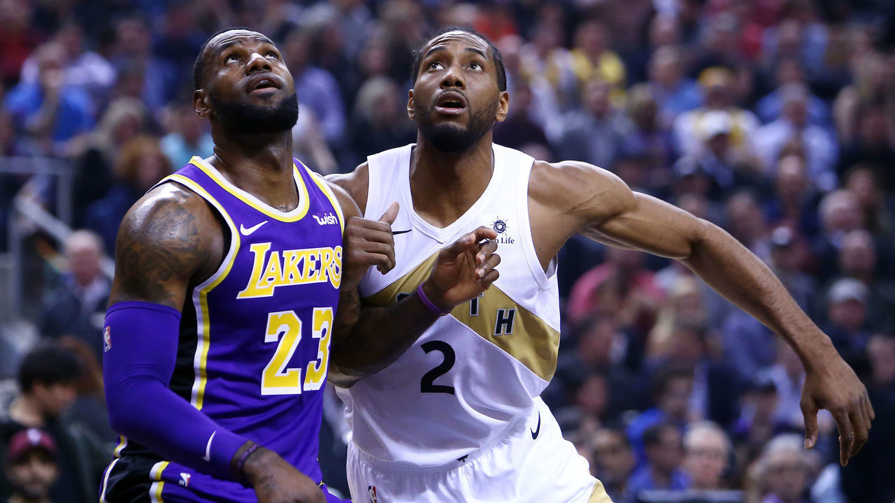 TORONTO, ON - MARCH 14: LeBron James #23 of the Los Angeles Lakers battles for space with Kawhi Leonard #2 of the Toronto Raptors during the first half of an NBA game at Scotiabank Arena on March 14, 2019 in Toronto, Canada.