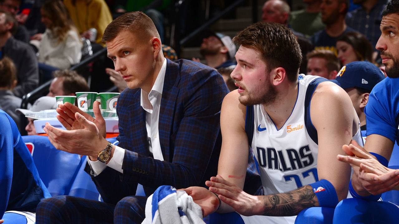 DENVER, CO - MARCH 14: Kristaps Porzingis #6 and Luka Doncic #77 of the Dallas Mavericks react to a play during the game against the Denver Nuggets on March 14, 2019 at the Pepsi Center in Denver, Colorado. NOTE TO USER: User expressly acknowledges and agrees that, by downloading and/or using this photograph, user is consenting to the terms and conditions of the Getty Images License Agreement. Mandatory Copyright Notice: Copyright 2019 NBAE