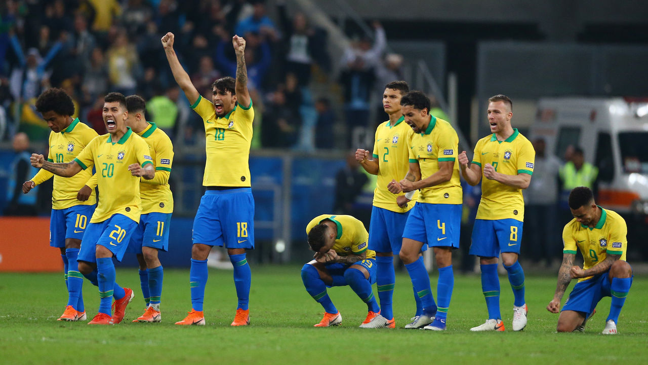 PORTO ALEGRE, BRAZIL - JUNE 27: Lucas Paqueta of Brazil and teammates celebrate a penalty during the shootout after the Copa America Brazil 2019 quarterfinal match between Brazil and Paraguay at Arena do Gremio on June 27, 2019 in Porto Alegre, Brazil.