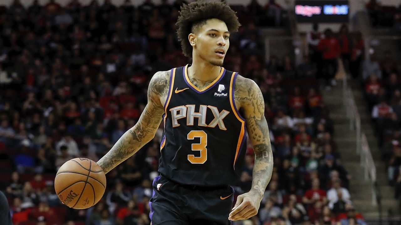 HOUSTON, TX - MARCH 15: Kelly Oubre Jr. #3 of the Phoenix Suns brings the ball up court by Austin Rivers #25 of the Houston Rockets in the second half at Toyota Center on March 15, 2019 in Houston, Texas.