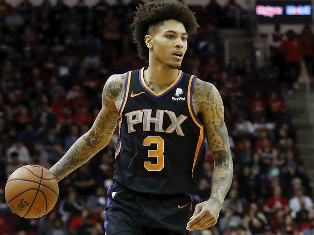 HOUSTON, TX - MARCH 15: Kelly Oubre Jr. #3 of the Phoenix Suns brings the ball up court by Austin Rivers #25 of the Houston Rockets in the second half at Toyota Center on March 15, 2019 in Houston, Texas.