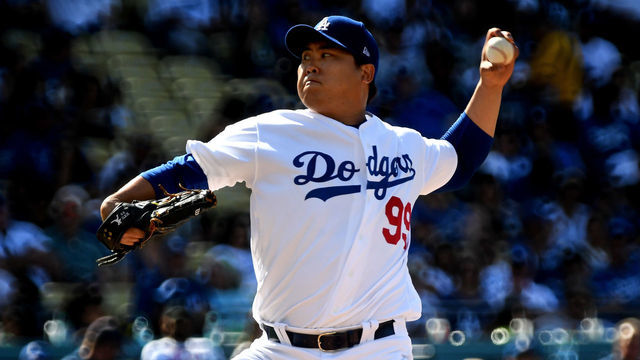 LOS ANGELES, CA - JUNE 22: Hyun-Jin Ryu #99 of the Los Angeles Dodgers throws to the plate against the Colorado Rockies in the first inning of a MLB baseball game at Dodger Stadium on Saturday, June 22, 2019 in Los Angeles, California.