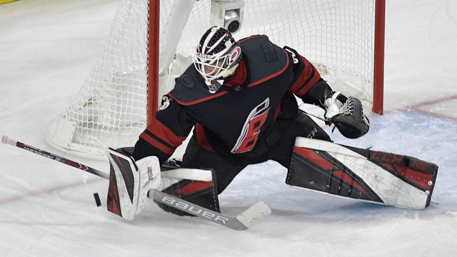 RALEIGH, NORTH CAROLINA - MAY 16: Curtis McElhinney #35 of the Carolina Hurricanes tends goal against the Boston Bruins during the third period in Game Four of the Eastern Conference Finals during the 2019 NHL Stanley Cup Playoffs at PNC Arena on May 16, 2019 in Raleigh, North Carolina.