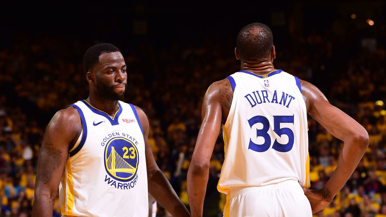 OAKLAND, CA - APRIL 13: Draymond Green #23 of the Golden State Warriors high-fives Kevin Durant #35 of the Golden State Warriors against the LA Clippers during Game One of Round One of the 2019 NBA Playoffs on April 13, 2019 at ORACLE Arena in Oakland, California. NOTE TO USER: User expressly acknowledges and agrees that, by downloading and or using this photograph, user is consenting to the terms and conditions of Getty Images License Agreement. Mandatory Copyright Notice: Copyright 2019 NBAE