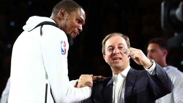 OAKLAND, CA - OCTOBER 17: Kevin Durant #35 of the Golden State Warriors receives his 2017 NBA Championship ring from team owner Joe Lacob prior to their NBA game against the Houston Rockets at ORACLE Arena on October 17, 2017 in Oakland, California.