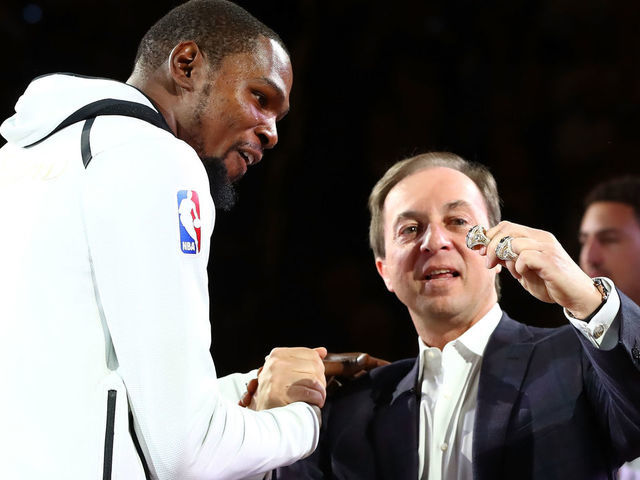 OAKLAND, CA - OCTOBER 17: Kevin Durant #35 of the Golden State Warriors receives his 2017 NBA Championship ring from team owner Joe Lacob prior to their NBA game against the Houston Rockets at ORACLE Arena on October 17, 2017 in Oakland, California.