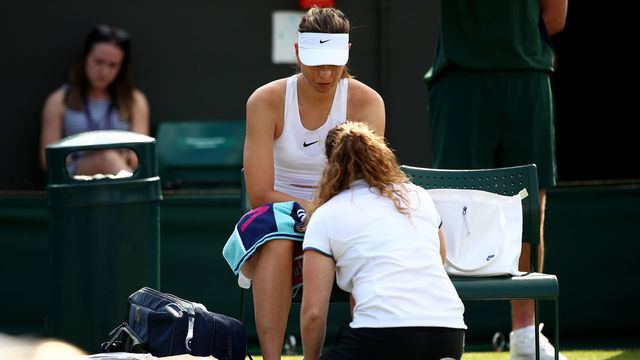 LONDON, ENGLAND - JULY 02: Maria Sharapova of Russia receives medical treatment in her Ladies' Singles first round match against Pauline Parmentier of France during Day two of The Championships - Wimbledon 2019 at All England Lawn Tennis and Croquet Club on July 02, 2019 in London, England.