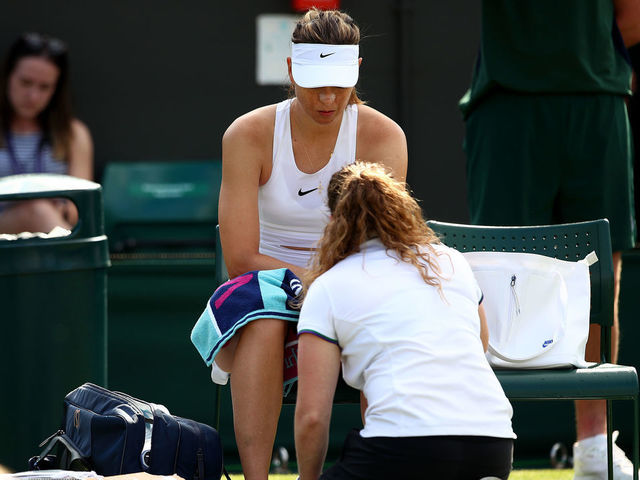 LONDON, ENGLAND - JULY 02: Maria Sharapova of Russia receives medical treatment in her Ladies' Singles first round match against Pauline Parmentier of France during Day two of The Championships - Wimbledon 2019 at All England Lawn Tennis and Croquet Club on July 02, 2019 in London, England.