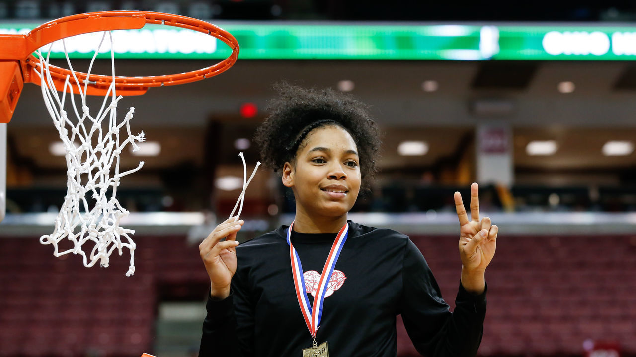 COLUMBUS, OH - MARCH 16: Toledo Rogers guard Zia Cooke cuts down the net during the awards ceremony following the Ohio High School Athletic Association (OHSAA) girls Division II state championship game between Toledo Rogers and Dayton Carroll on March 16, 2019 at Value City Arena in Columbus, Ohio.