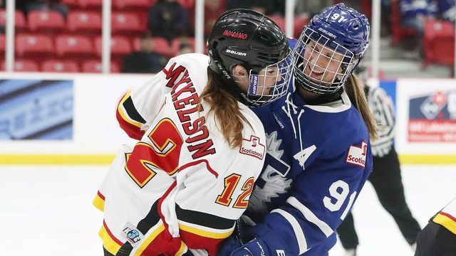 TORONTO, ON- JANUARY 21 - Toronto Furies Jenelle Kohanchuk (91) checks an Inferno player in a game against the Calgary Inferno at the MasterCard Centre for Hockey Excellence. The Toronto Furies are one of five teams in the Canadian Women's Hockey League. The CWHL is the highest level of hockey for women. The League strives to become a professional league where the players earn a pay cheque to play. in Toronto. January 21, 2017. Steve Russell/Toronto Star (Steve Russell/Toronto Star via Getty Images)