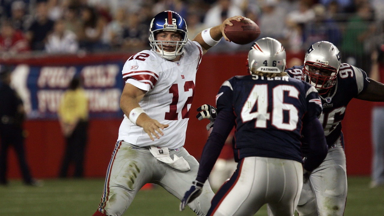 New York Giants quarterback Jared Lorenzen (12) throws a pass under pressure during the pre-season game against the New England Patriots at Gillette Stadium in Foxboro, MA. The Giants defeated the Patriots 27-3.