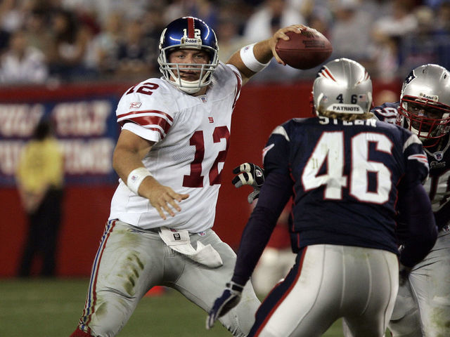New York Giants quarterback Jared Lorenzen (12) throws a pass under pressure during the pre-season game against the New England Patriots at Gillette Stadium in Foxboro, MA. The Giants defeated the Patriots 27-3.