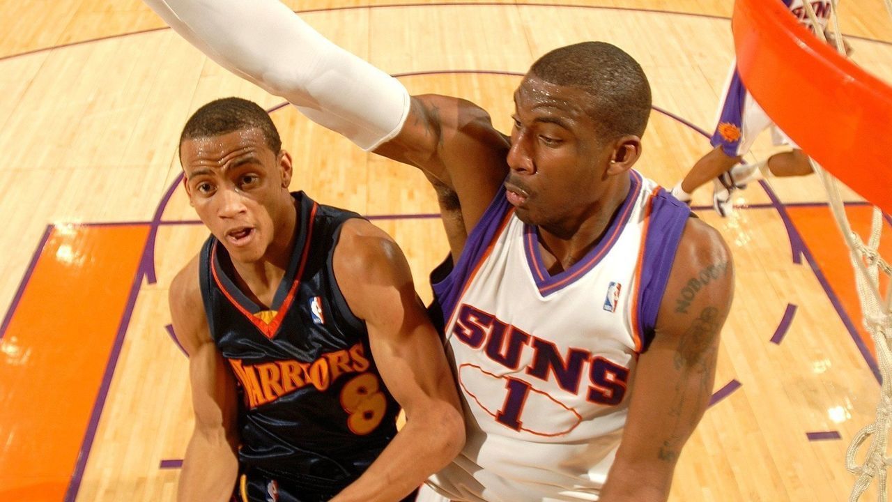 PHOENIX - JANUARY 7: Amare Stoudemire #1 of the Phoenix Suns tries to block the shot of Monta Ellis #8 of the Golden State Warriors in an NBA game played on January 7, 2007, at U.S. Airways Center in Phoenix, Arizona. Mandatory Copyright Notice: Copyright 2007 NBAE