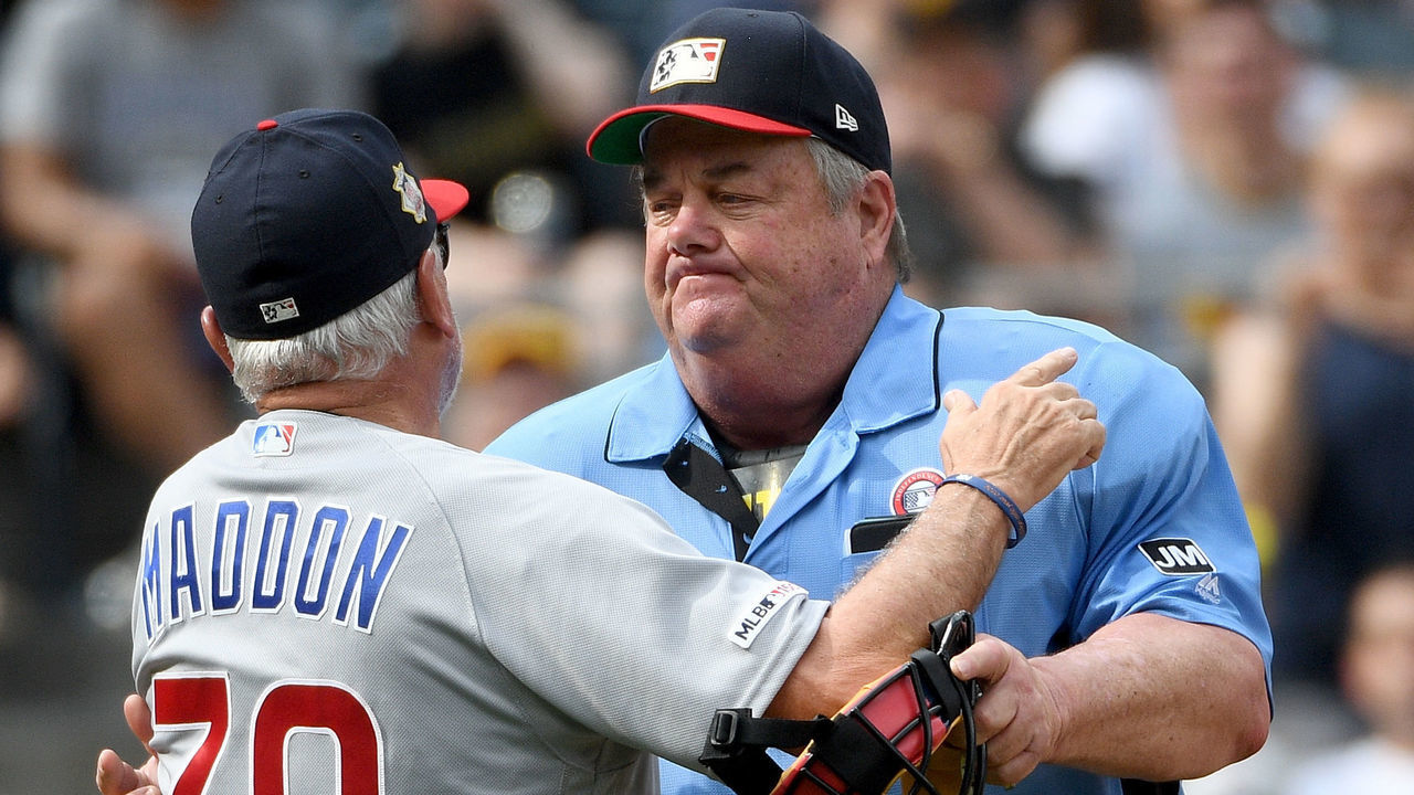 PITTSBURGH, PA - JULY 04: Joe Maddon #70 of the Chicago Cubs is restrained by umpire Joe West #22 as he yells at the Pirates dugout after being ejected in the fourth inning during the game against the Pittsburgh Pirates at PNC Park on July 4, 2019 in Pittsburgh, Pennsylvania.