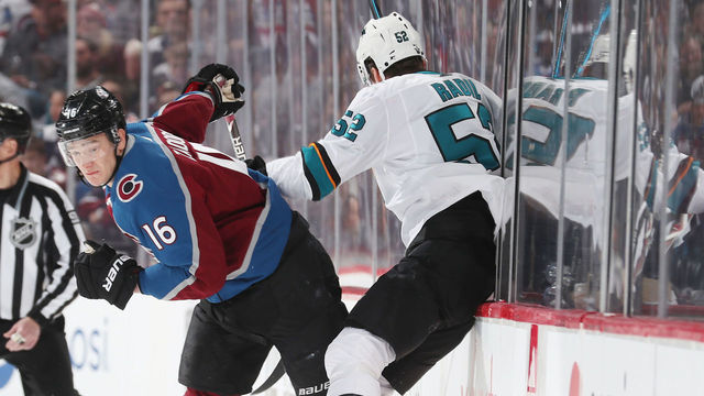DENVER, CO - APRIL 30: Nikita Zadorov #16 of the Colorado Avalanche checks Lukas Radil #52 of the San Jose Sharks into the glass in Game Three of the Western Conference Second Round during the 2019 NHL Stanley Cup Playoffs at the Pepsi Center on April 30, 2019 in Denver, Colorado.