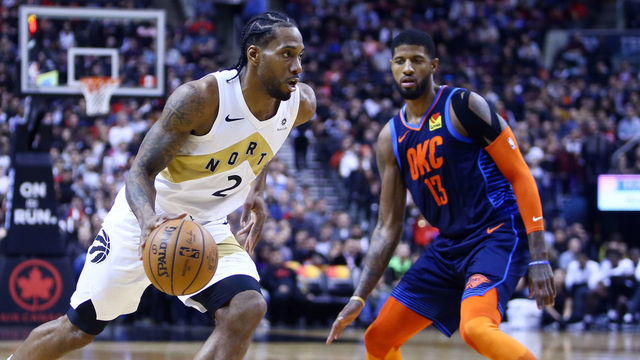 TORONTO, ON - MARCH 22: Kawhi Leonard #2 of the Toronto Raptors dribbles the ball as Paul George #13 of the Oklahoma City Thunder defends during the second half of an NBA game at Scotiabank Arena on March 22, 2019 in Toronto, Canada.
