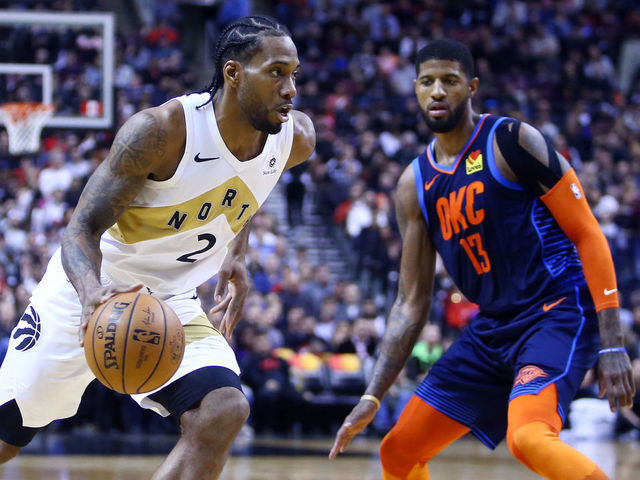 TORONTO, ON - MARCH 22: Kawhi Leonard #2 of the Toronto Raptors dribbles the ball as Paul George #13 of the Oklahoma City Thunder defends during the second half of an NBA game at Scotiabank Arena on March 22, 2019 in Toronto, Canada.
