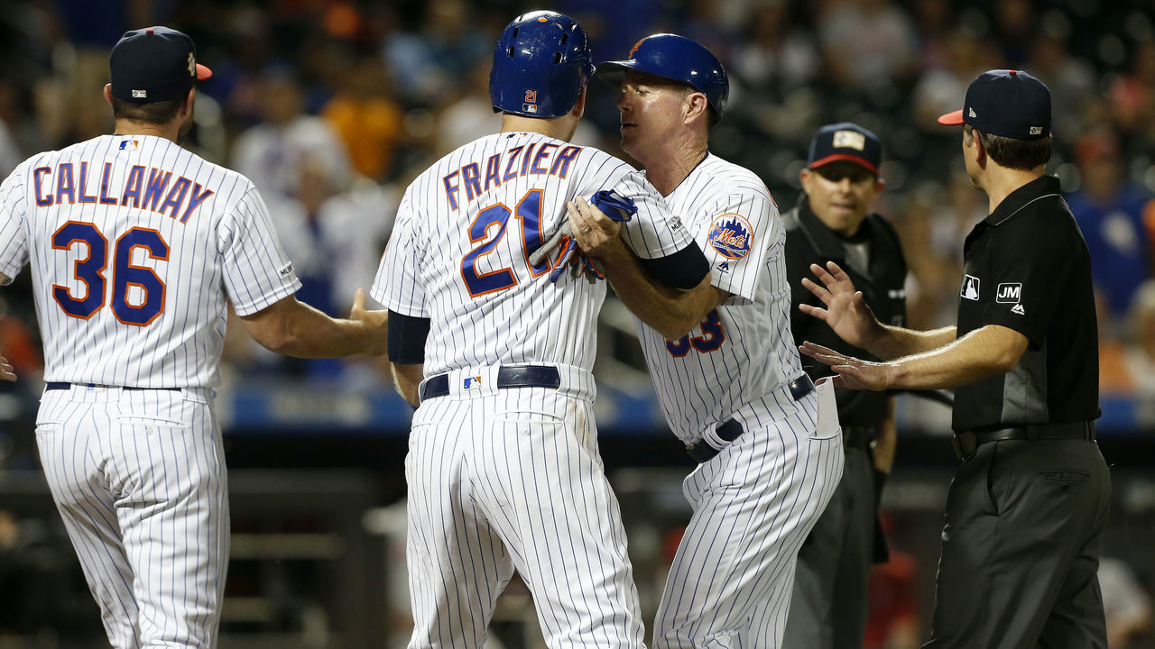 NEW YORK, NEW YORK - JULY 06: Todd Frazier #21 of the New York Mets is held back by first base coach Glenn Sherlock #53 as he argues with the umpires after being ejected during the fifth inning against the Philadelphia Phillies at Citi Field on July 06, 2019 in New York City.