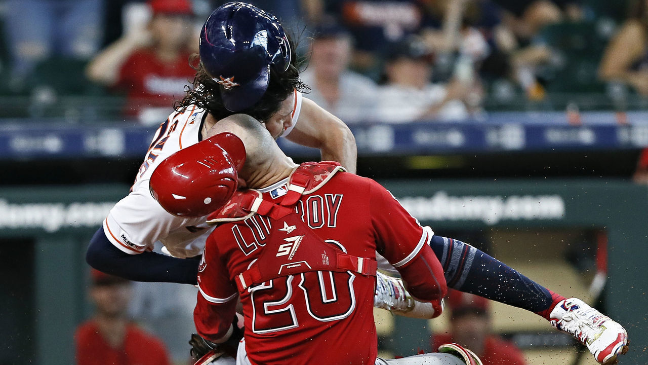 HOUSTON, TEXAS - JULY 07: Jake Marisnick #6 of the Houston Astros collides with catcher Jonathan Lucroy #20 of the Los Angeles Angels of Anaheim as he attempts to score in the eighth inning at Minute Maid Park on July 07, 2019 in Houston, Texas. Marisnick was called out under the home plate collision rule.