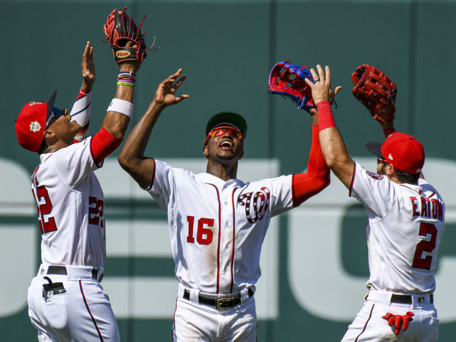 WASHINGTON, DC - JULY 07: Washington Nationals left fielder Juan Soto (22), center fielder Victor Robles (16) and right fielder Adam Eaton (2) celebrate following the game between the Kansas City Royals and the Washington Nationals on July 7, 2019, at Nationals Park, in Washington D.C.