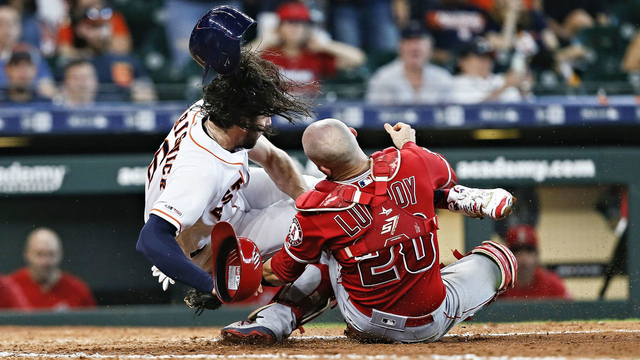 HOUSTON, TEXAS - JULY 07: Jake Marisnick #6 of the Houston Astros collides with catcher Jonathan Lucroy #20 of the Los Angeles Angels of Anaheim as he attempts to score in the eighth inning at Minute Maid Park on July 07, 2019 in Houston, Texas. Marisnick was called out under the home plate collision rule.